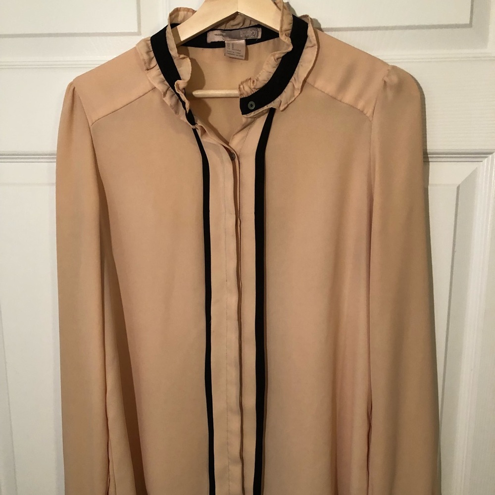 Beautiful nude and black ruffled collar blouse.